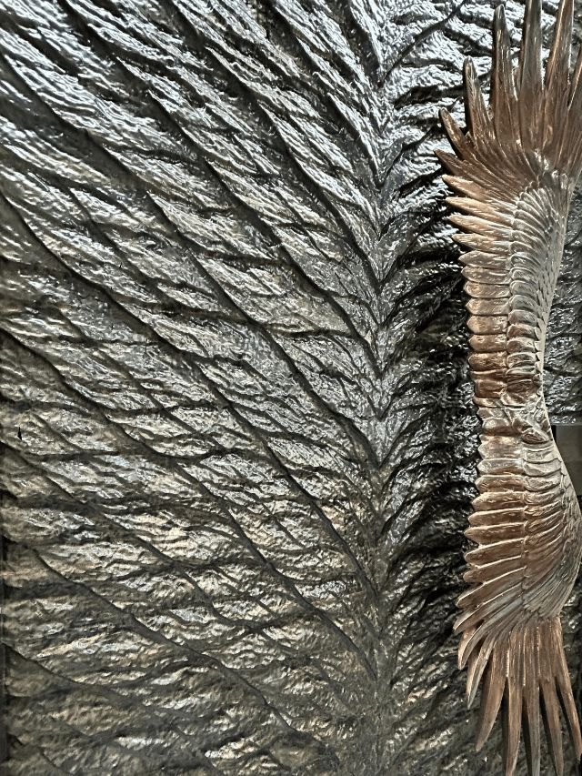 Hand-carved feather-textured door surface detail